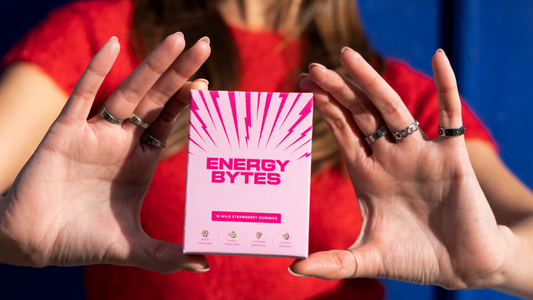 Hands presenting the Wild Strawberry Flavour of Energy Bytes